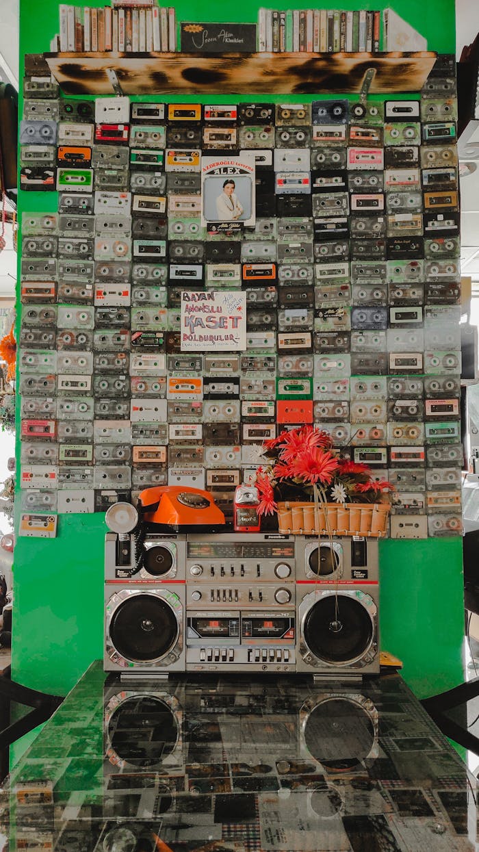 Collection of vintage cassettes and a boombox in a nostalgic market stall.